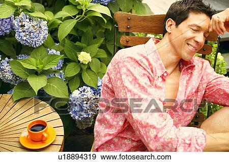 Stock Photo - Close-up of a mature man sitting on a chair with his eyes closed. Fotosearch