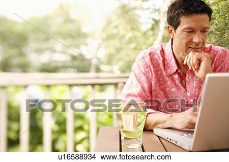 Close-up of a mature man using a laptop View Large Photo Image Picture - Close-up of a mature man using a laptop. Fotosearch