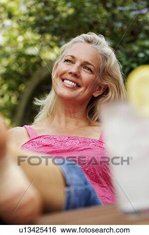 Close-up of a mature woman smiling View Large Photo Image Stock Photograph - Close-up of a mature woman smiling. Fotosearch