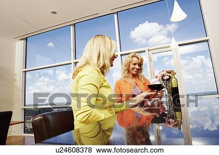 Low angle view of a mature woman and a mid adult woman toasting glasses of wine View Large Photo Image Stock Photo - Low angle view of a mature woman and a mid adult woman toasting glasses of wine. Fotosearch