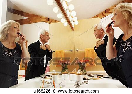 Mature couple dressing up in the bathroom View Large Photo Image Stock Photo - Mature couple dressing up in the bathroom. Fotosearch