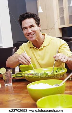 Portrait of a mature man taking salad from a bowl View Large Photo Image Stock Image - Portrait of a mature man taking salad from a bowl. Fotosearch