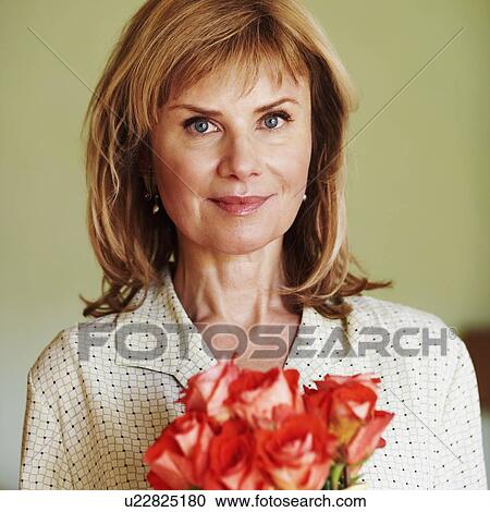 Portrait of a mature woman with flowers View Large Photo Image Stock Image - Portrait of a mature woman with flowers. Fotosearch