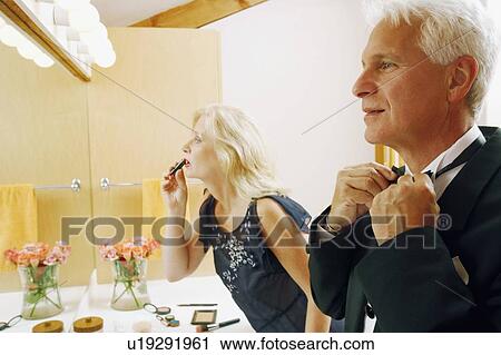 Side profile of a mature couple dressing up in the bathroom View Large Photo Image Stock Image - Side profile of a mature couple dressing up in the bathroom. Fotosearch