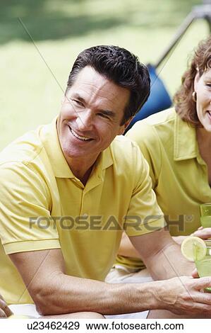 Side profile of a mature man holding a glass of lemonade View Large Photo Image Stock Photo - Side profile of a mature man holding a glass of lemonade. Fotosearch