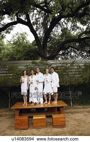 Two mature men and three mature women standing side by side on the table View Large Photo Image Picture - Two mature men and three mature women standing side by side on the table. Fotosearch