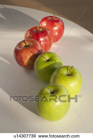 Stock Photo - Apples in row on table. Fotosearch