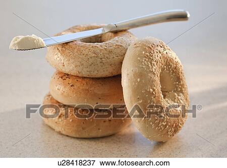 Stock Photo - Bagel and knife with butter. Fotosearch