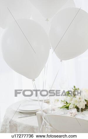 Stock Photograph - "Balloons at wedding table setting, studio shot". Fotosearch