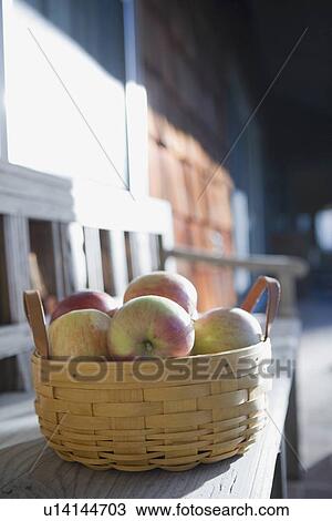 Stock Image - Basket of apples in street. Fotosearch