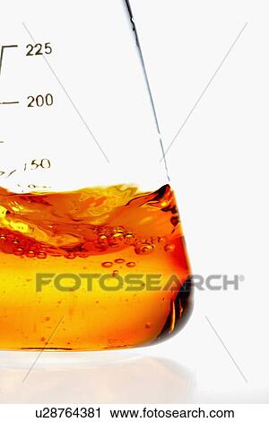 Stock Image - Beaker with orange liquid. Fotosearch