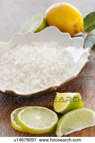 Bowl of bath salt and slices of citrus on table View Large Photo Image Stock Photo - Bowl of bath salt and slices of citrus on table. Fotosearch