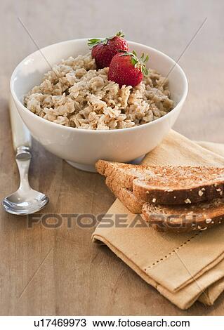 Stock Image - Bowl of cereal with fruits. Fotosearch