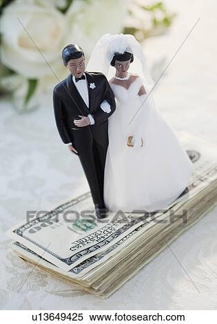 Bride and groom cake toppers on money View Large Photo Image Stock Photography - Bride and groom cake toppers on money. Fotosearch