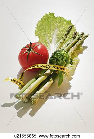 Stock Photography - Bunch of organically grown vegetables wrapped with tape. Fotosearch