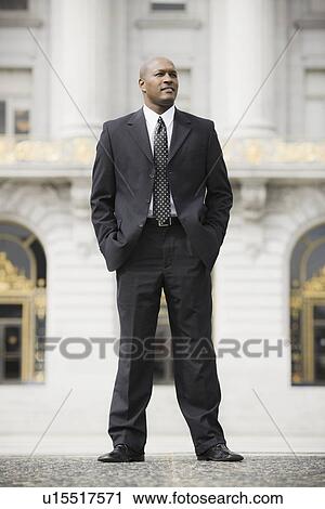Stock Image - "Businessman standing outside office building, San Francisco, California, USA". Fotosearch