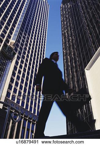 Stock Image - Businessman walking on the street. Fotosearch