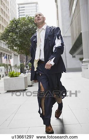 "Businessman wearing torn clothing, walking in street, San Francisco, California, USA" View Large Photo Image Stock Photo - "Businessman wearing torn clothing, walking in street, San Francisco, California, USA". Fotosearch