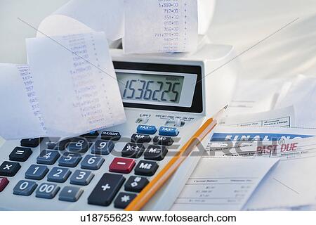 Stock Image - Calculator and bills. Fotosearch