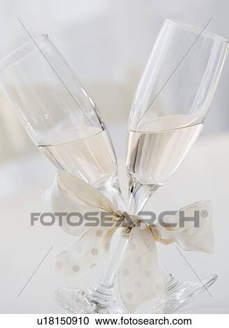 Stock Image - Champagne glasses tied with ribbon. Fotosearch