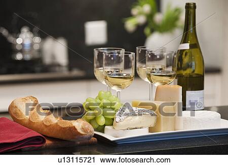 Cheeses and wine on kitchen worktop View Large Photo Image Stock Image - Cheeses and wine on kitchen worktop. Fotosearch
