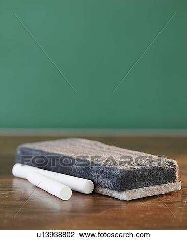 Stock Image - "Close-up of chalk and blackboard eraser, studio shot". Fotosearch