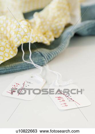 Close-up of clothing with sale tags View Large Photo Image Stock Image - Close-up of clothing with sale tags. Fotosearch