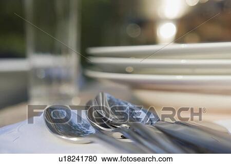 Close-up of cutlery and plates on dinner table View Large Photo Image Stock Image - Close-up of cutlery and plates on dinner table. Fotosearch