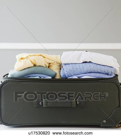 Stock Image - Close-up of packed suitcase. Fotosearch
