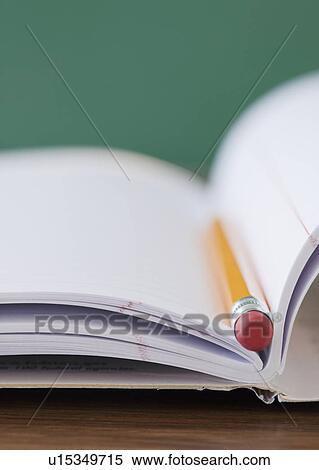 Stock Photography - "Close-up of pencil on notebook, studio shot". Fotosearch