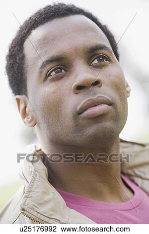 "Close-up of pensive man, outdoors" View Large Photo Image Stock Image - "Close-up of pensive man, outdoors". Fotosearch