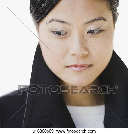 "Close-up of pensive young woman, studio shot" View Large Photo Image Stock Photo - "Close-up of pensive young woman, studio shot". Fotosearch