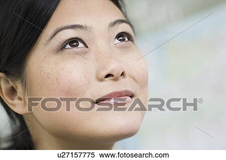 Stock Photography - Close-up of pensive young woman. Fotosearch