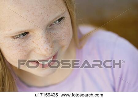 Stock Photography - Close-up of smiling girl (10-12). Fotosearch