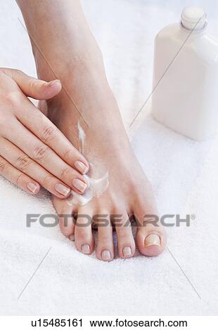 Close-up of woman moisturizing foot View Large Photo Image Stock Image - Close-up of woman moisturizing foot. Fotosearch