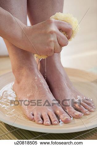 Stock Photography - Close-up of woman washing feet. Fotosearch