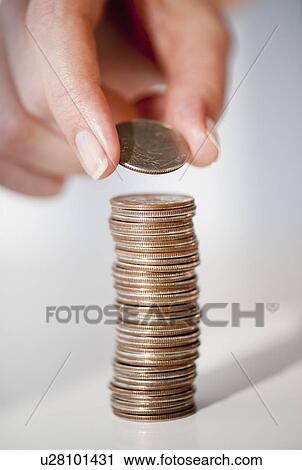 Close-up of woman's hand stacking coins View Large Photo Image Stock Image - Close-up of woman's hand stacking coins. Fotosearch