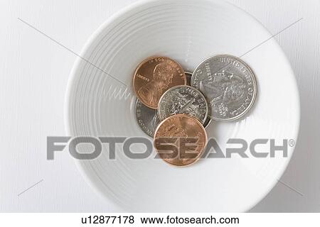 Stock Photo - Coins in bowl. Fotosearch