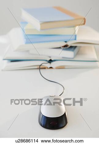 "Computer mouse near pile of books, studio shot" View Large Photo Image Picture - "Computer mouse near pile of books, studio shot". Fotosearch