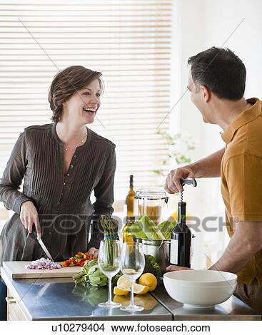 Picture - Couple preparing food in kitchen. Fotosearch