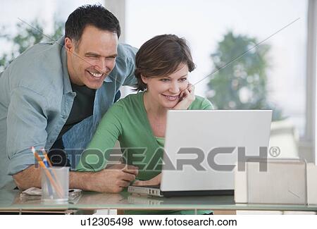 Stock Photo - Couple using laptop. Fotosearch