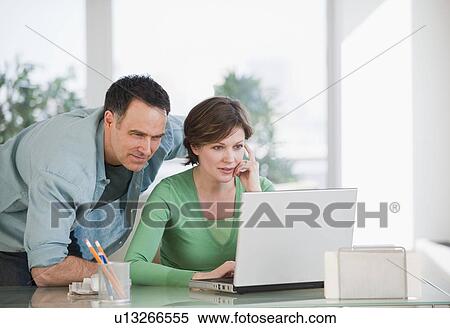 Stock Photography - Couple using laptop. Fotosearch