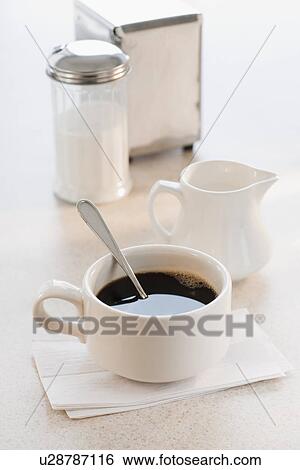 Cup of coffee with milk and sugar on table View Large Photo Image Stock Photograph - Cup of coffee with milk and sugar on table. Fotosearch