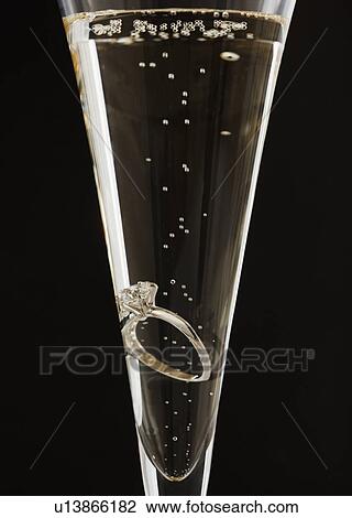 Engagement ring in champagne glass View Large Photo Image Stock Image - Engagement ring in champagne glass. Fotosearch