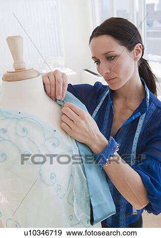 Stock Photo - Female tailor at work. Fotosearch