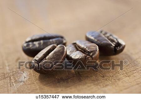 Stock Photo - "Four roast coffee beans, studio shot". Fotosearch