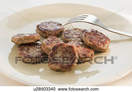 Fried slices of sausage and fork on plate View Large Photo Image Stock Image - Fried slices of sausage and fork on plate. Fotosearch
