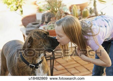 Stock Photo - Girl (10-12) kissing boxer. Fotosearch