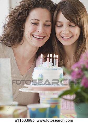 Girl (10-12 years) celebrating birthday with mother View Large Photo Image Stock Photography - Girl (10-12 years) celebrating birthday with mother. Fotosearch