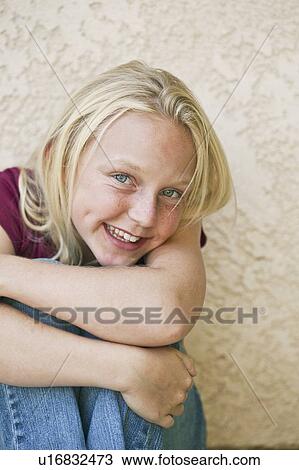 Stock Image - "Girl (13-15) smiling, portrait". Fotosearch